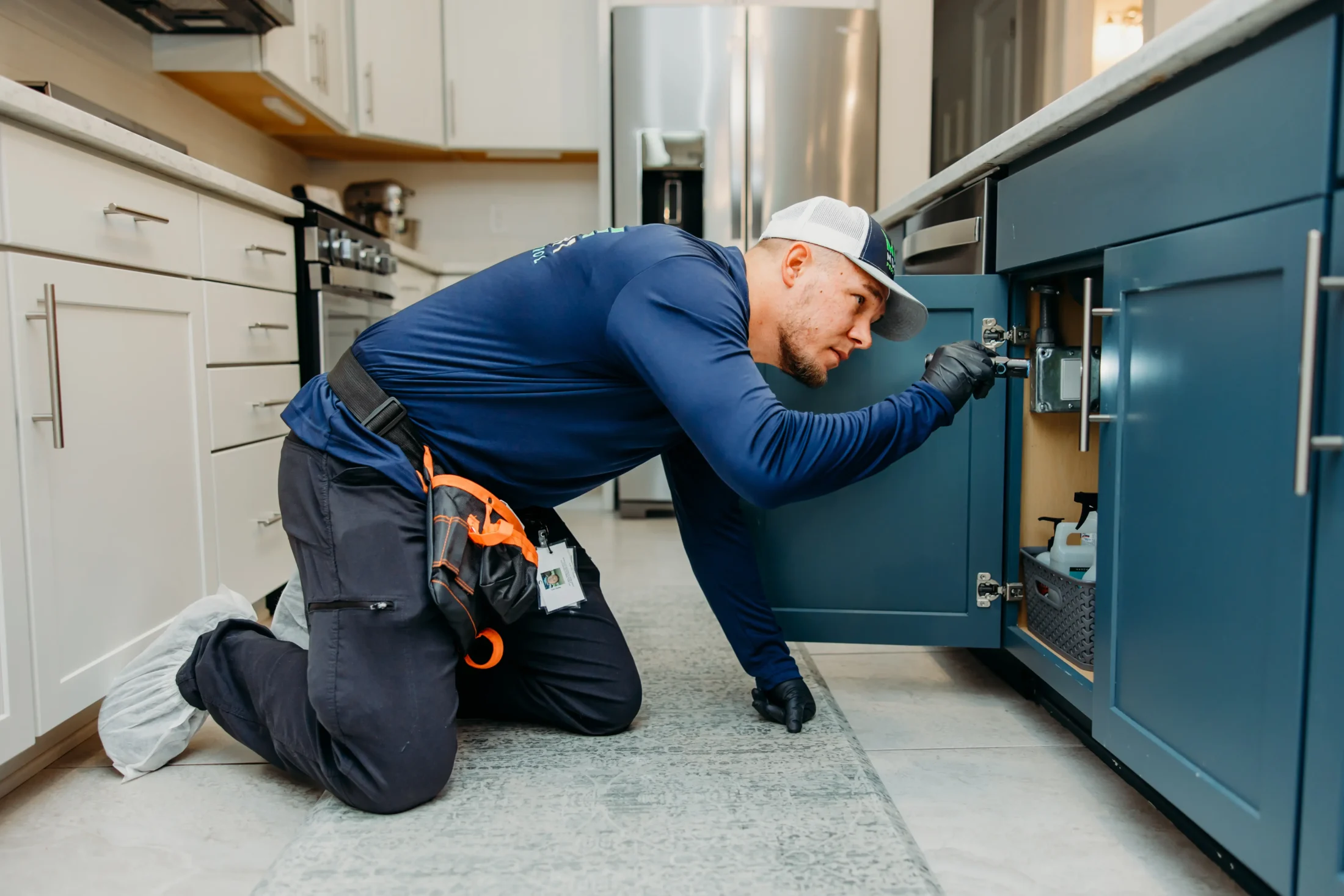 Mike Nugent working looking under cabinet